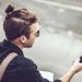 manbun styled man holding mobile