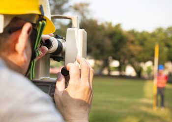 Surveyor engineer with partner making measure
