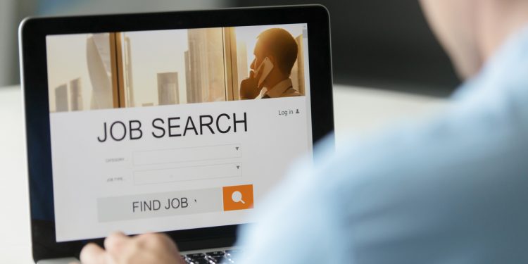 Monitor view over a male shoulder, job search title