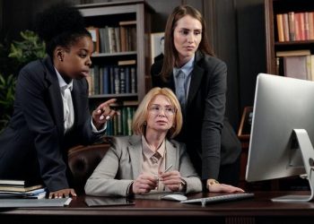 Female attorneys checking out their law firm's website