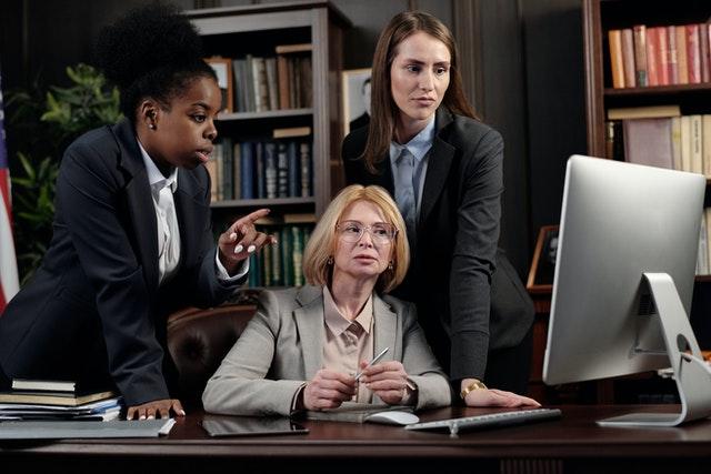 Female attorneys checking out their law firm's website