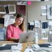 woman in red long sleeve shirt sitting in front of silver macbook